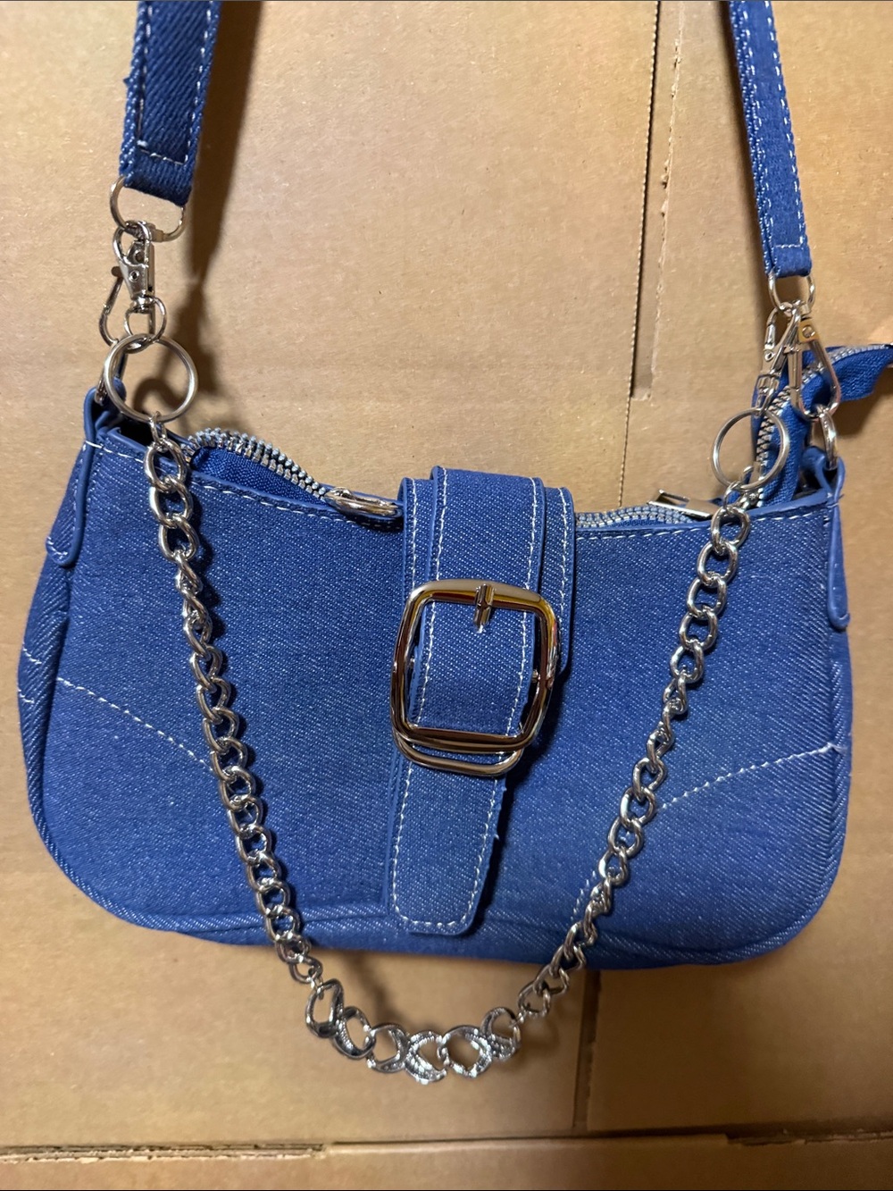 Blue Denim Crossbody Bag with Chain Accent. Bag not for sale